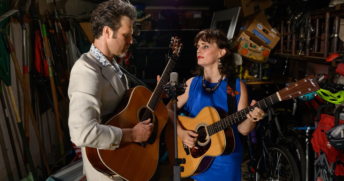Molly Venter and Eben Pariser of Goodnight Moonshine playing acoustic guitars