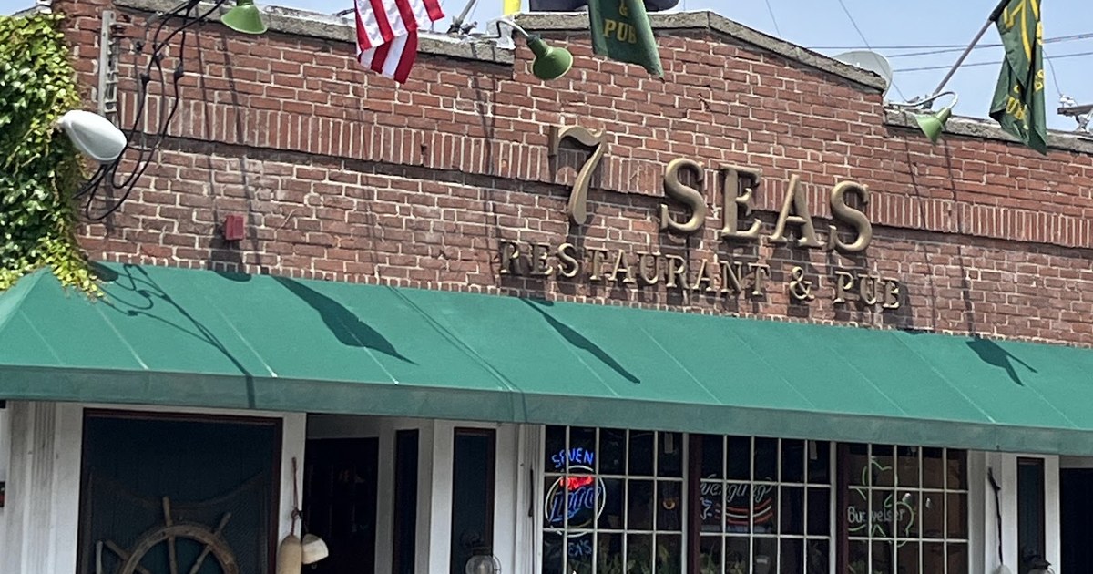 The 7 Seas Restaurant & Pub sign and green awning at 16 New Haven Ave. in downtown Milford