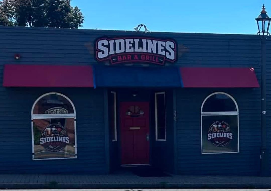 Sidelines Bar & Grill storefront with red and blue awnings at 229 Bridgeport Avenue in Milford