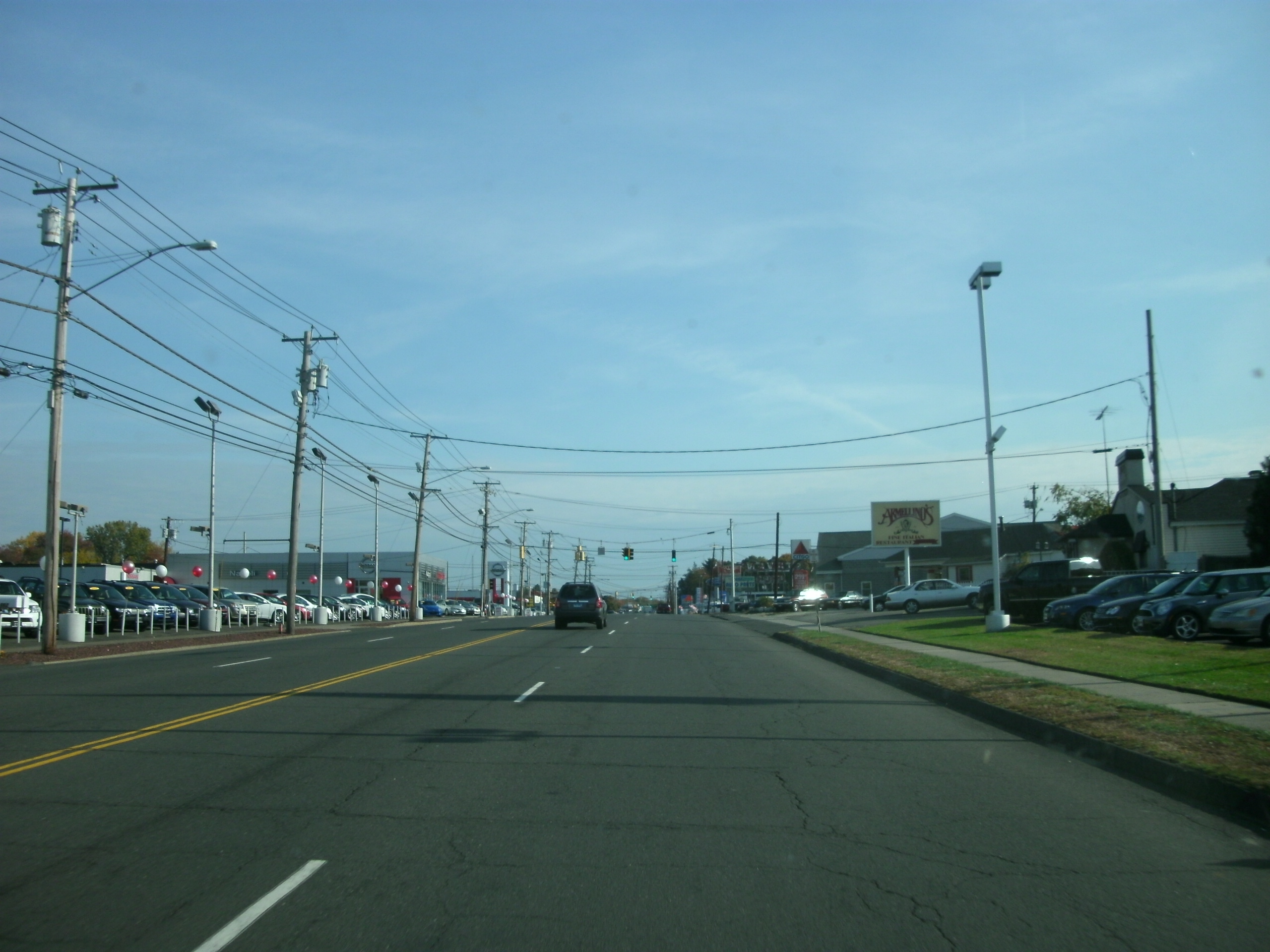 Traffic on US Route 1 in Milford, Connecticut, a multi-lane road lined with car dealerships and utility poles