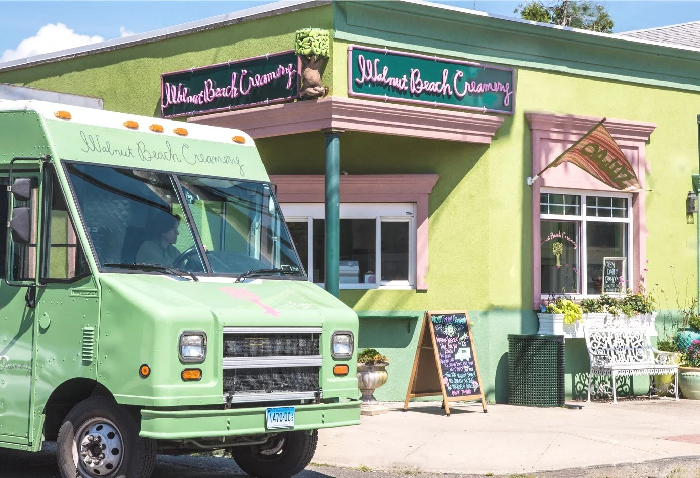 Walnut Beach Creamery's green and pink shop at 17 Broadway in Milford with its ice cream truck out front